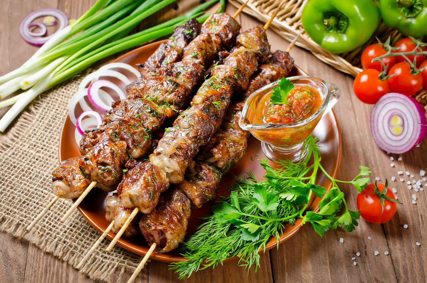 Grilled beef liver kebabs on a dark wooden background